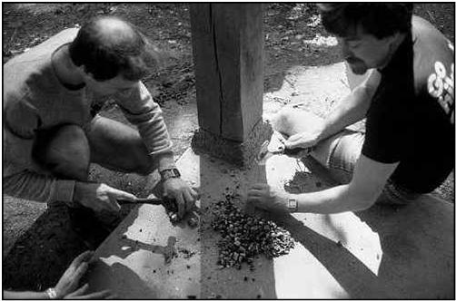 Roy Kempston and Geoff Barton breaking carbide into manageable pieces